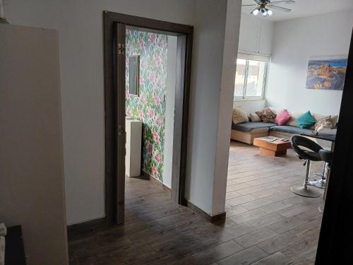 a living room with a door open to a living room at Spacious 3 Bedroom Apt Near the Sea in St Paul's Bay