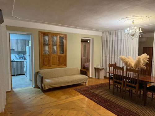 a living room with a couch and a table at Guest House T&N in Kutaisi