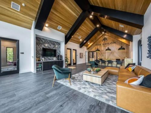 a living room with a couch and a table at Luxurious New Unit 1Bd1Ba Pool, Golf Sim in Austin