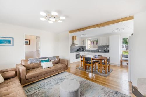 a living room with a couch and a table at Modern Coastal Escape in Triabunna in Triabunna