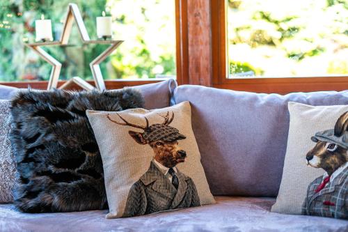 a couch with two pillows with a bear and a hat at Livadi cozy villa in Arachova