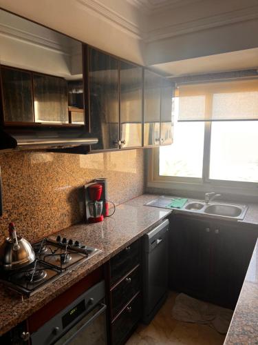a kitchen with a stove and a sink in it at Appartement vue mer in Casablanca