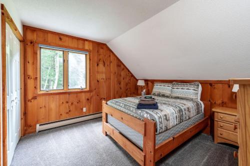 a bedroom with a bed and a window at Cozy Villager Chalet w Mountain Views and Firepit in Dover