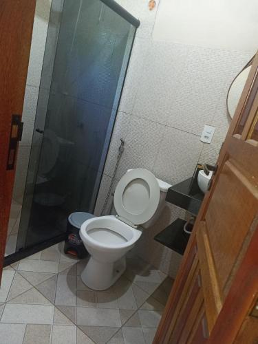 a bathroom with a toilet and a shower at Casa da Andressa in Conceição da Barra