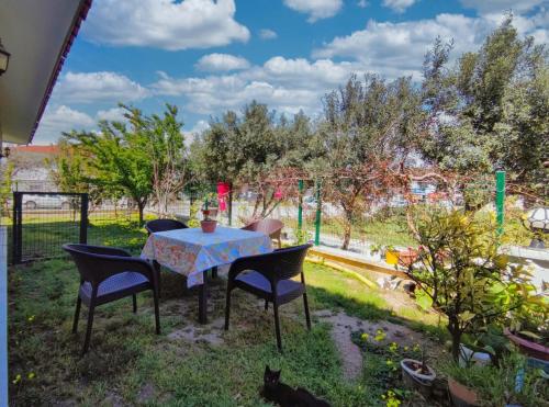 a table and chairs in a yard with a garden at enjoy in Cesme