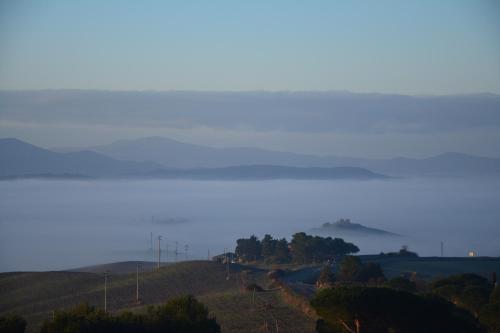 a misty view of a road on a hill at Podere Campiano in Volterra