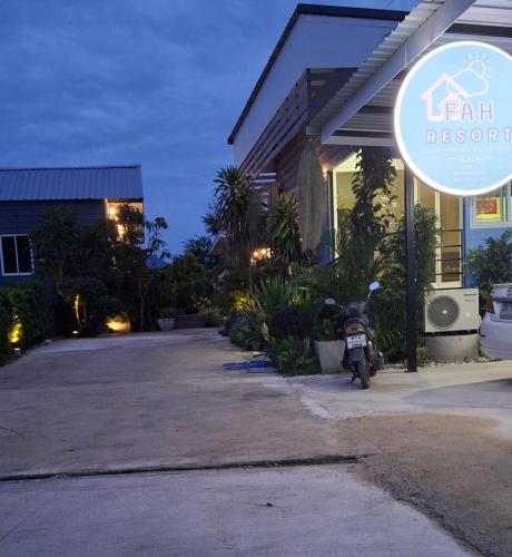 a motorcycle parked outside of a house at night at ฟ้ารีสอร์ต FAH Resort in Ban Nong Khang