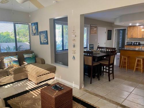 a living room and kitchen with a couch and a table at Fabulous one bedroom in West Bay in West Bay