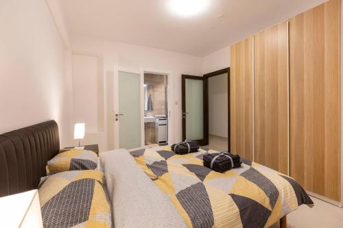two bags on a bed in a room at Beautiful Modern Central 2br Apt in Taʼ Xbiex