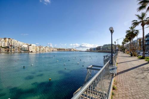 a view of a river with people swimming in it at Penthouse, Seaview, Beautiful 2br Apt 4 in Marsaskala