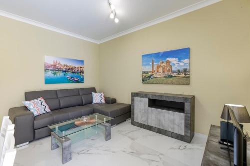 a living room with a couch and a fireplace at Penthouse, Seaview, Beautiful 2br Apt 4 in Marsaskala
