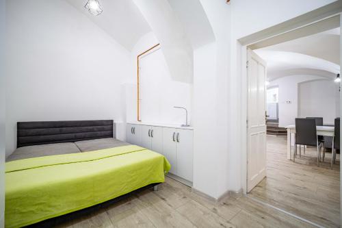 a bedroom with a bed and a sink and a table at St Elizabeth Apartment, Kosice Old Town in Košice