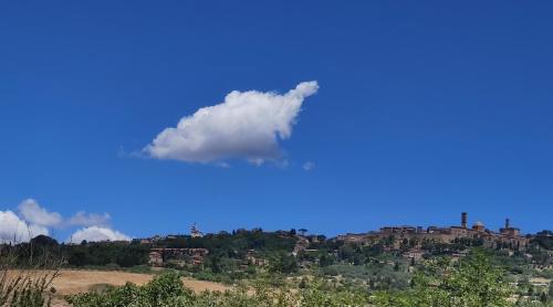 a cloud in the sky over a city at Podere Campiano in Volterra