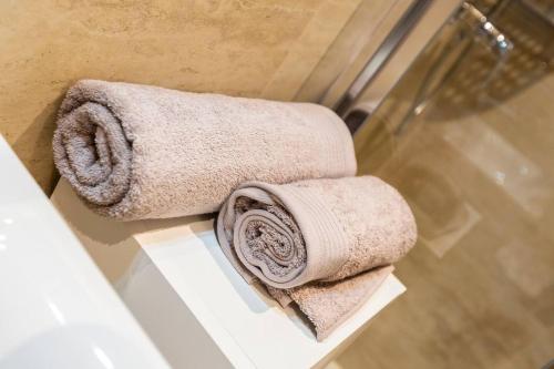 a couple of towels on a shelf in a bathroom at Beautiful Modern Central 2br Apt in Taʼ Xbiex
