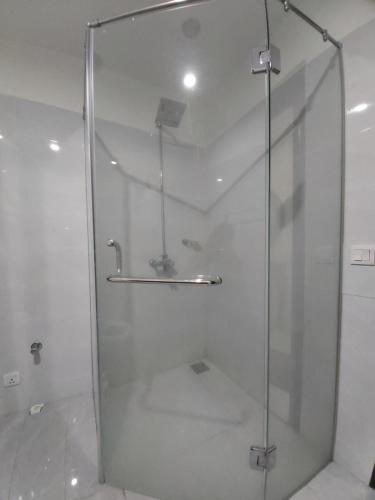 a shower with a glass door in a bathroom at Zameen Opal in Lahore