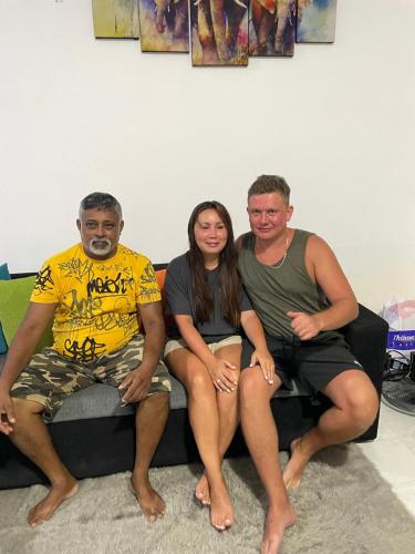 a group of three people sitting on a couch at The Glory Villa Transit Hotel in Katunayake