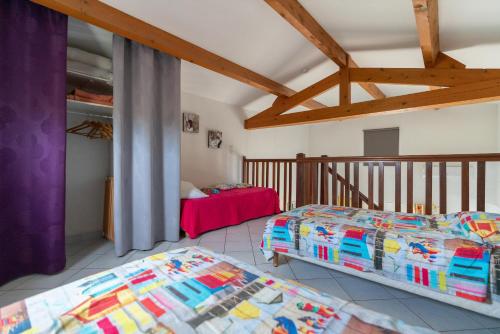 a bedroom with two beds and a balcony at Villa Avec Piscine partagée in Cap d'Agde