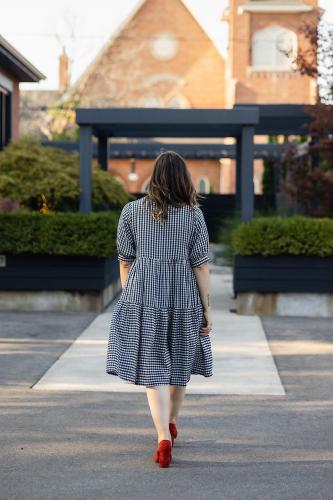 a woman in a dress walking down a street at The VanderMarck Boutique Hotel in Collingwood