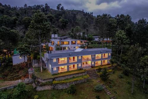 an overhead view of a house with lights on at Shola Gardens , Kotagiri in Kotagiri