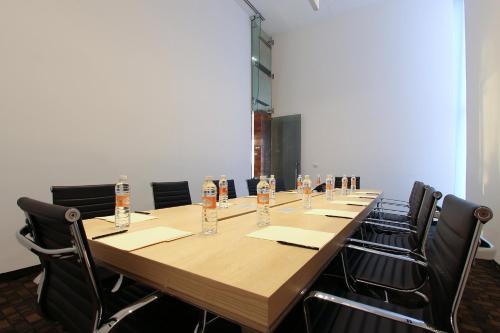 a long table in a room with chairs around it at Fiesta Inn Merida in Mérida