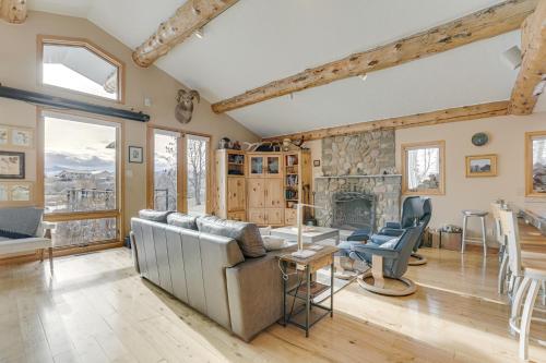 a living room with a couch and a fireplace at Stunning Sheridan Ranch Villa Mountain View! in Sheridan