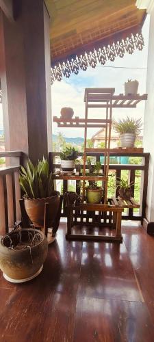 a room with potted plants sitting on a table at 欢乐时光精品酒店 in Luang Prabang