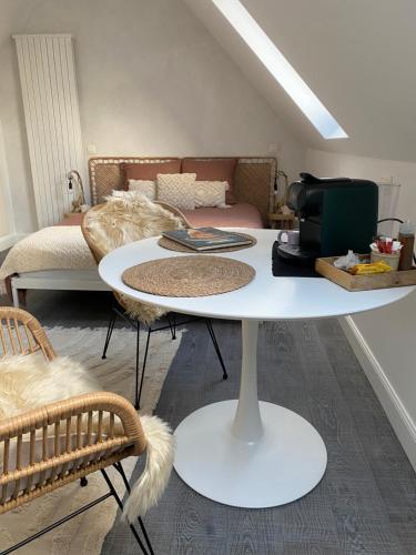a white table in a room with a bed at The Conservatory a cosy private attic - Central between Ghent Antwerp Brussels & Brugge in Lokeren