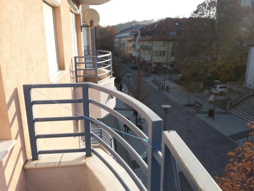 a balcony with a railing on a building at Pedestrian Street Apartment in Hévíz