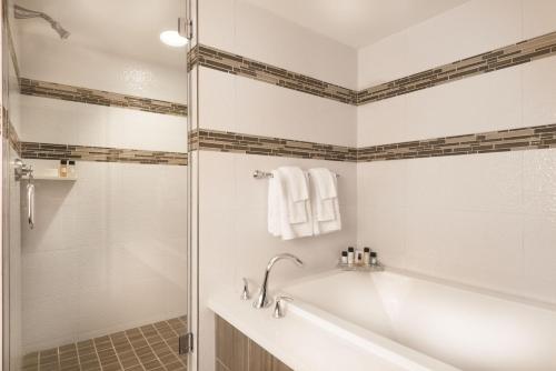 a bathroom with a tub and a glass shower at Flamingo Las Vegas Hotel & Casino in Las Vegas