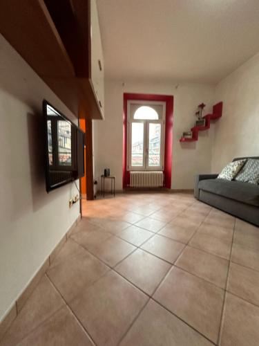 a living room with a couch and a window at Comfy apartment in Lecco 2 in Lecco