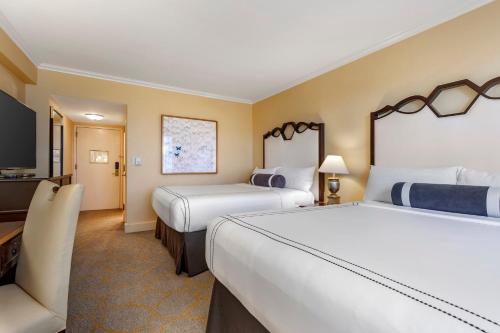 a hotel room with two beds and a flat screen tv at Omni Shoreham Hotel in Washington