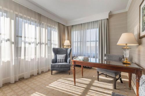 a hotel room with a desk and a chair and a desk and a chair at Omni Shoreham Hotel in Washington