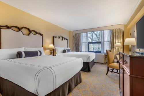 a hotel room with two beds and a window at Omni Shoreham Hotel in Washington