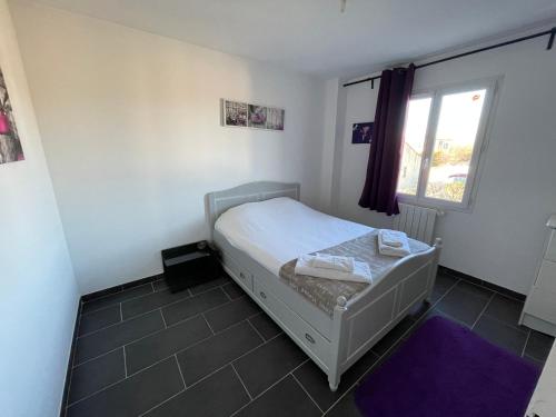 une chambre avec un lit et une fenêtre dans l'établissement Maison avec piscine et jacuzzi chauffée, à Jonquières-et-Saint-Vincent