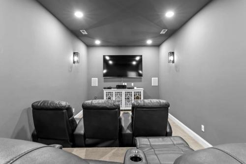 a living room with two chairs and a flat screen tv at Lake Escape by AvantStay Lakefront Private Dock in Mooresville