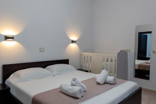 a bedroom with a large bed with towels on it at Mariksel HOTEL in Ksamil