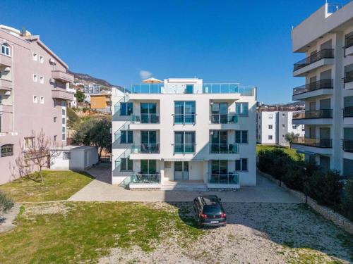 an apartment building with a car parked in front of it at Apartments 4U in Dobra Voda