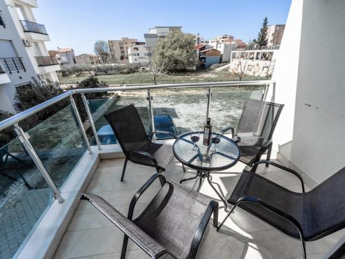 a balcony with chairs and a table on a building at Apartments 4U in Dobra Voda