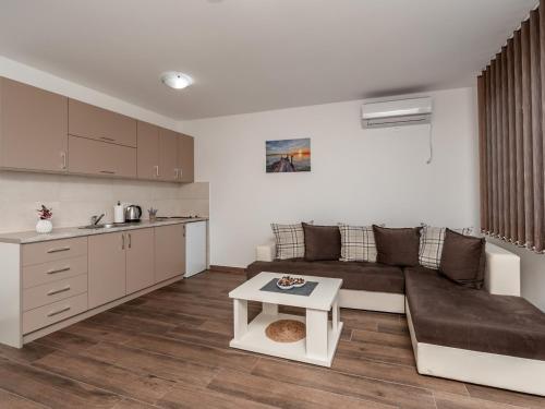 a living room with a couch and a table at Apartments 4U in Dobra Voda