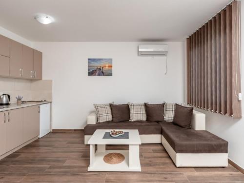 a living room with a couch and a table at Apartments 4U in Dobra Voda