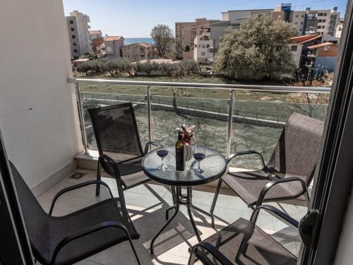 a table and chairs on a balcony with a view at Apartments 4U in Dobra Voda