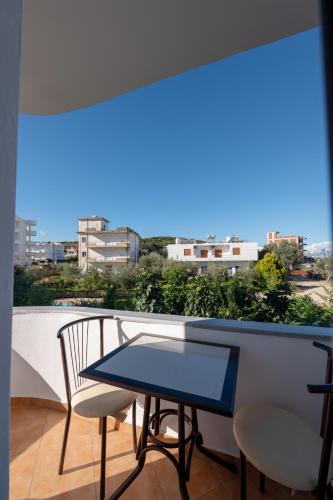 a table and chairs on a balcony with a view at Mariksel HOTEL in Ksamil