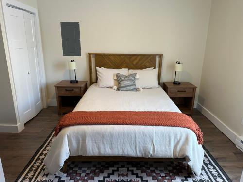 a bedroom with a large bed with two night stands at The Innwoods - Two Bedroom Apartment in Tannersville