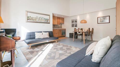 a living room with a blue couch and a table at Vila Santa Maria - Cosy Guest House in Sintra