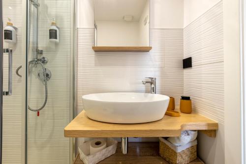 a bathroom with a sink and a shower at saige holidays in Alghero