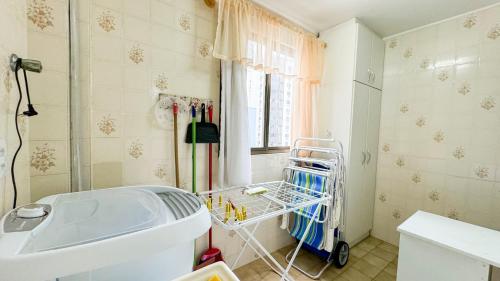 a bathroom with a white tub and a sink at 200 metros da Praia Central na Avenida Brasil próximo à Roda Gigante e Shopping Atlântico in Balneário Camboriú