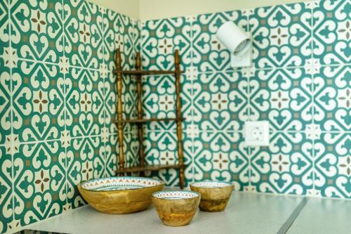 three bowls on a table in a room with a wall at Corinthian Blue Retreat in Katakoúli