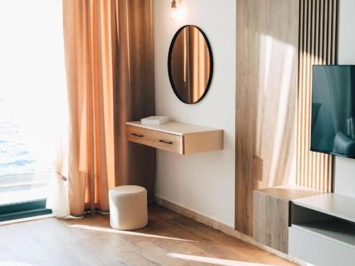 a living room with a mirror and a tv at Hayal Boutique Hotel in Bar