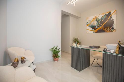 a living room with a desk and a chair at Pomaria Boutique Residences in Lefkada Town