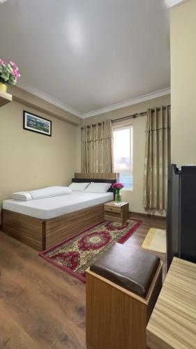 a bedroom with two beds and a window at House of Forrest, Service Apartments in Kathmandu